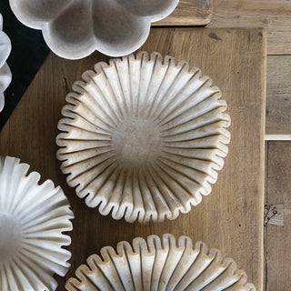 Close-up of decorative stone bowls on a wooden surface