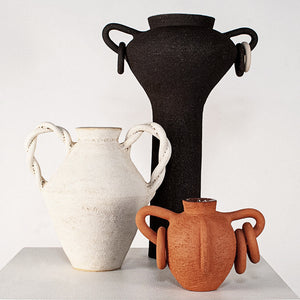 Three ceramic vases in black, white, and terracotta 