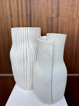 2 white vases on wooden background