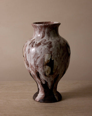 Ceramic vase with marbled design on a beige background