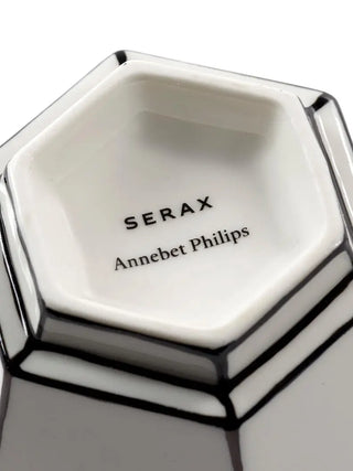 Hexagonal black and white cappuccino cup with 'SERAX Annebet Philips' branding on a white background