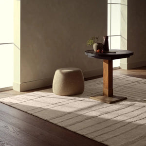 Textured beige wool rug with wavy line  in a beautiful room