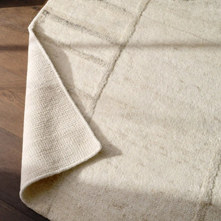 Textured beige wool rug with wavy line 