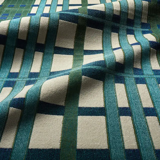 Close-up of a textured fabric with blue and green geometric pattern