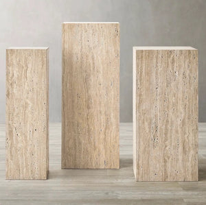 Three stone pedestals of different sizes 