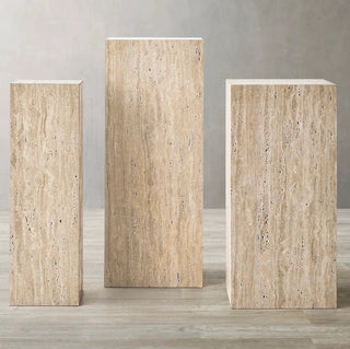 Three stone pedestals of different sizes 