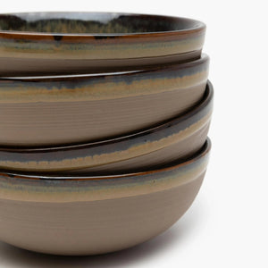 Stack of ceramic bowls with a speckled pattern