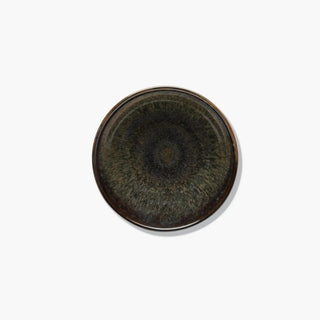 Round ceramic dish with a textured surface