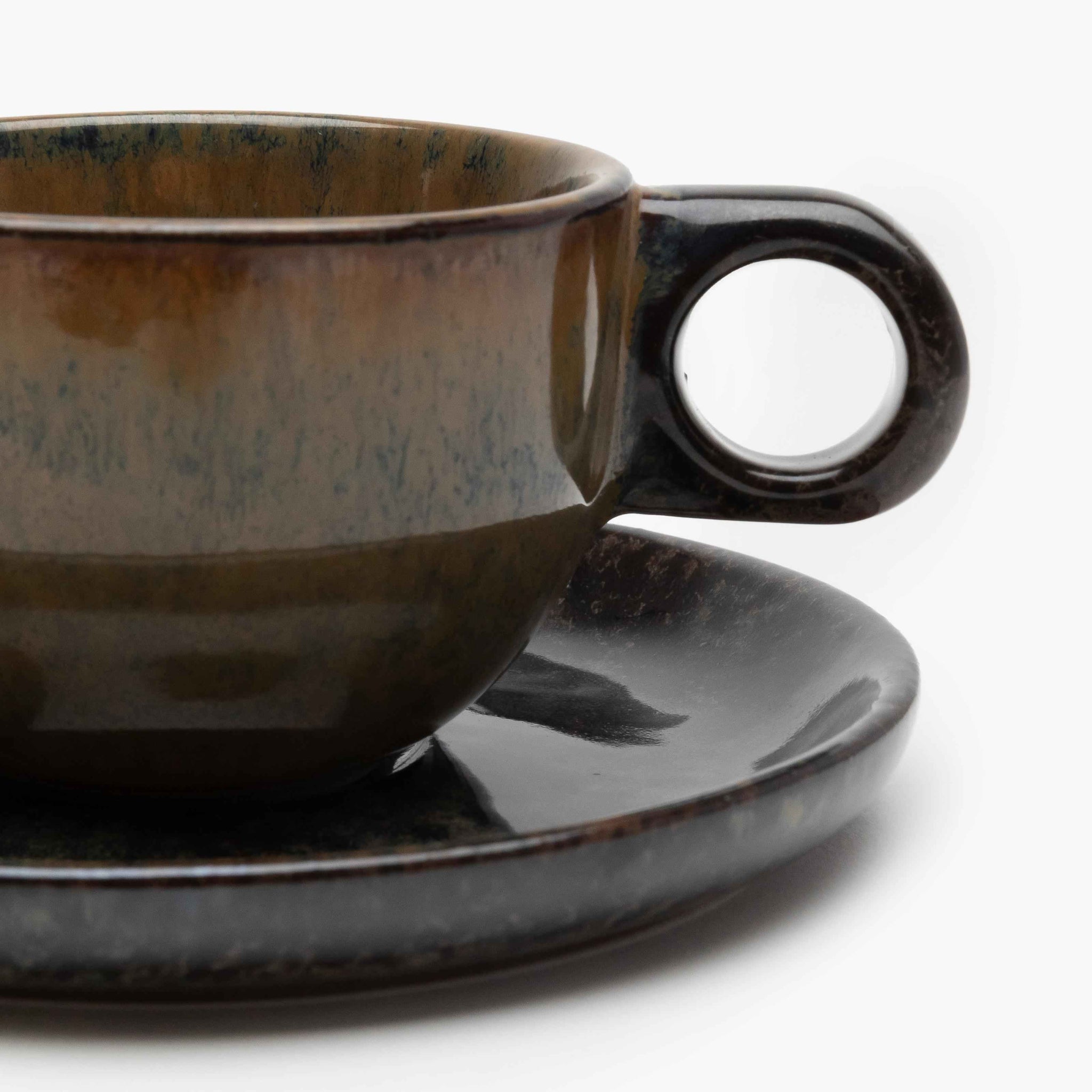 Ceramic cup and saucer set on a white background