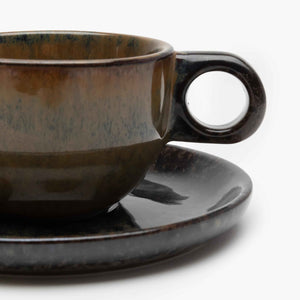 Ceramic cup and saucer set on a white background