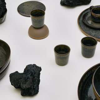 Set of green ceramic tableware elements.