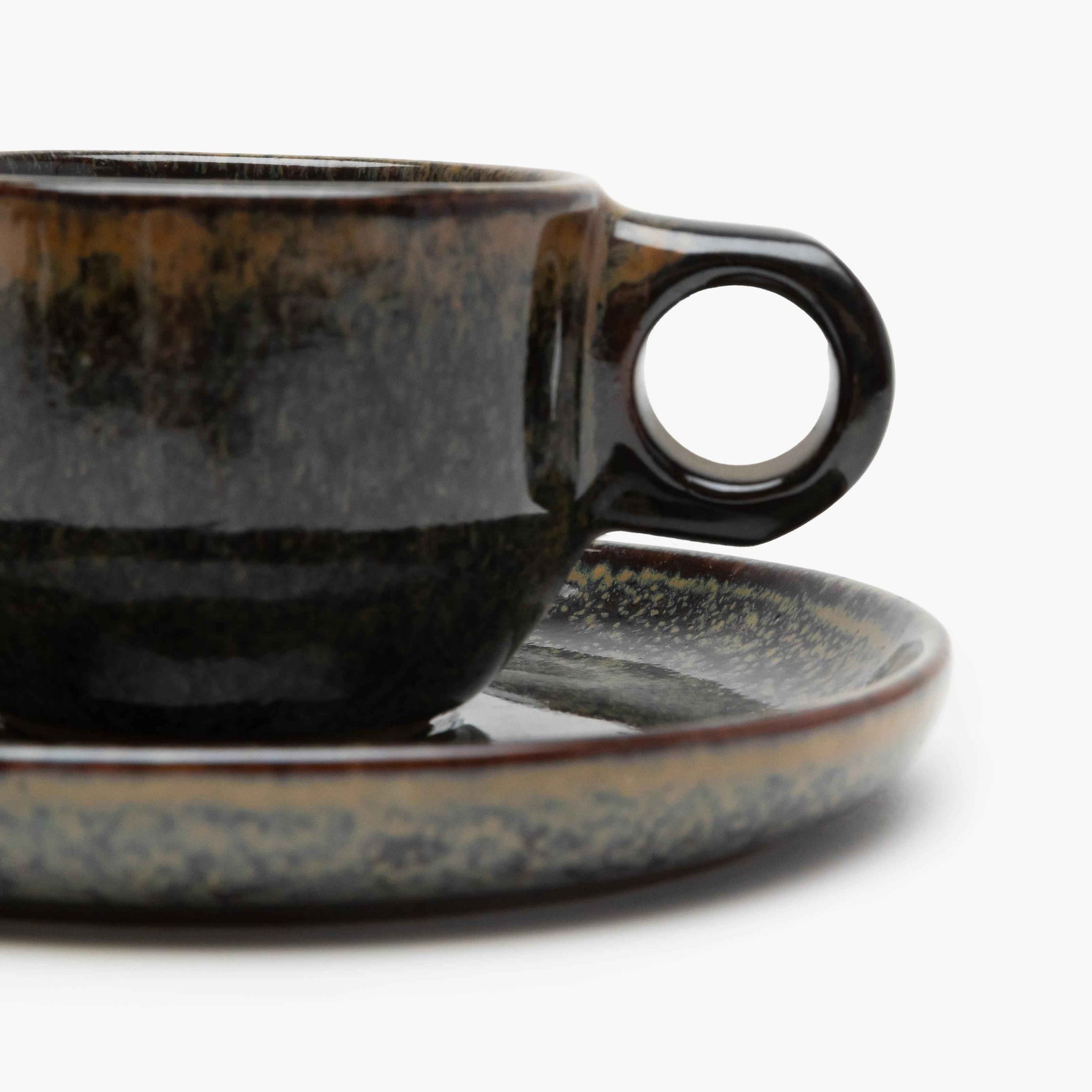 Ceramic cup and saucer set with a speckled design 