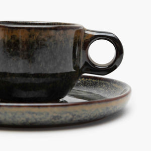Ceramic cup and saucer set with a speckled design 
