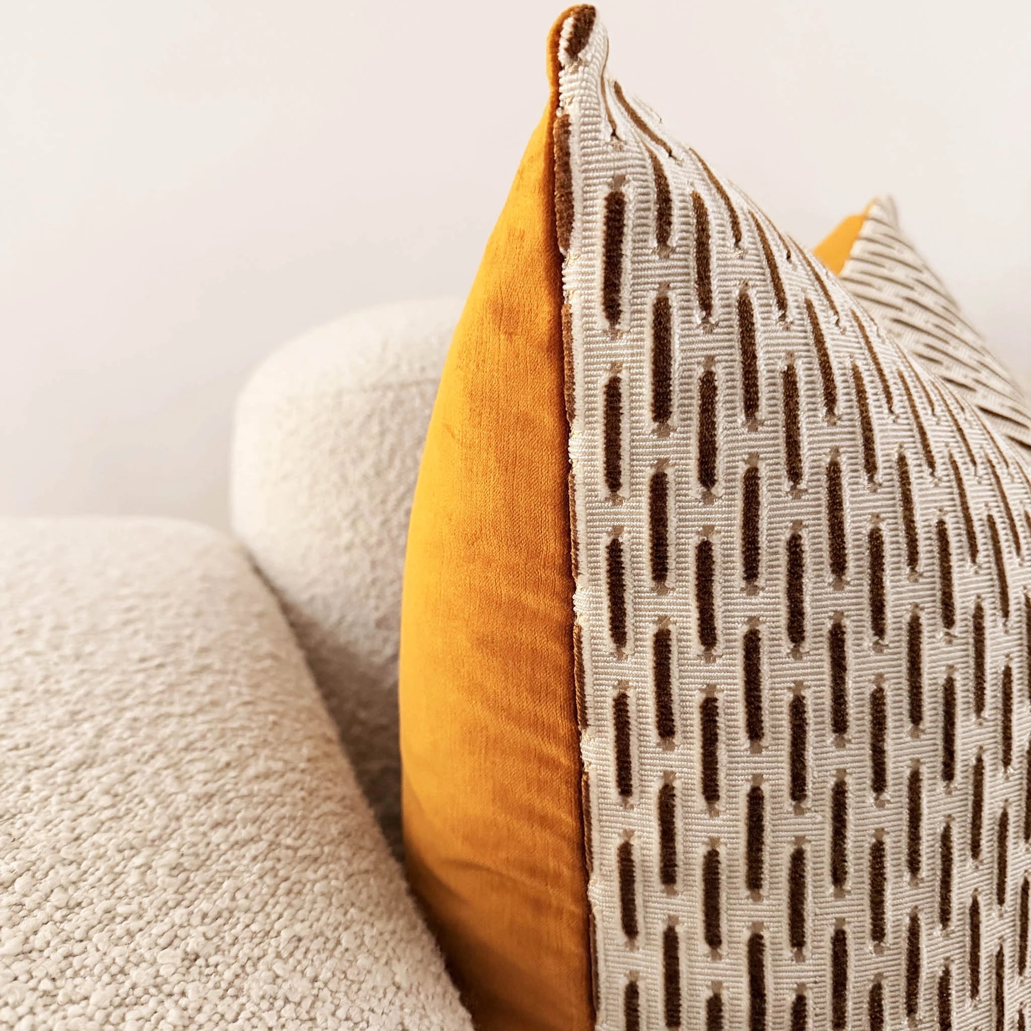 Close-up of a textured pillow with a geometric pattern on a neutral background