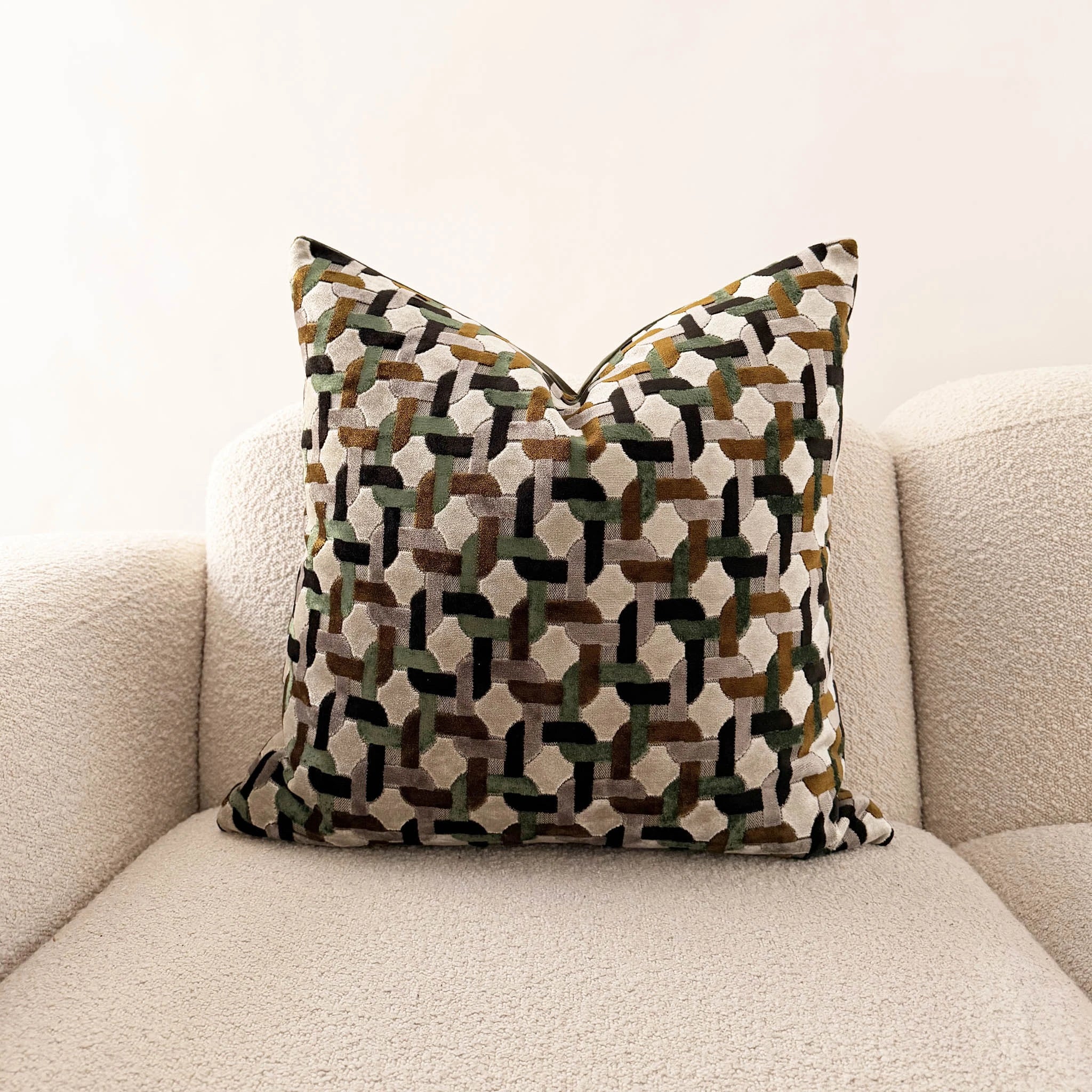geometric velvet throw pillow on white sofa 