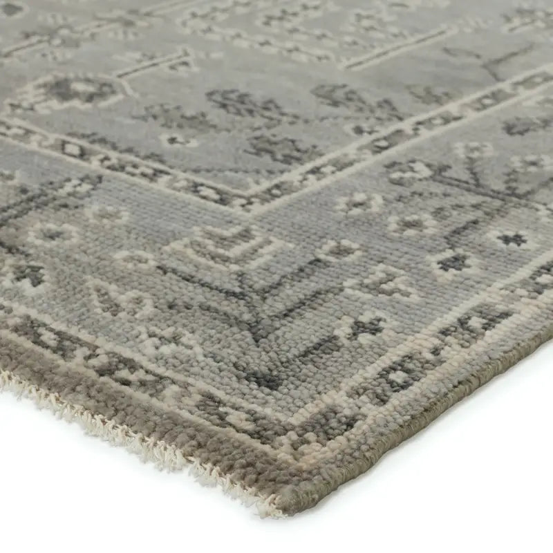 Close-up of a textured gray rug with geometric pattern 
