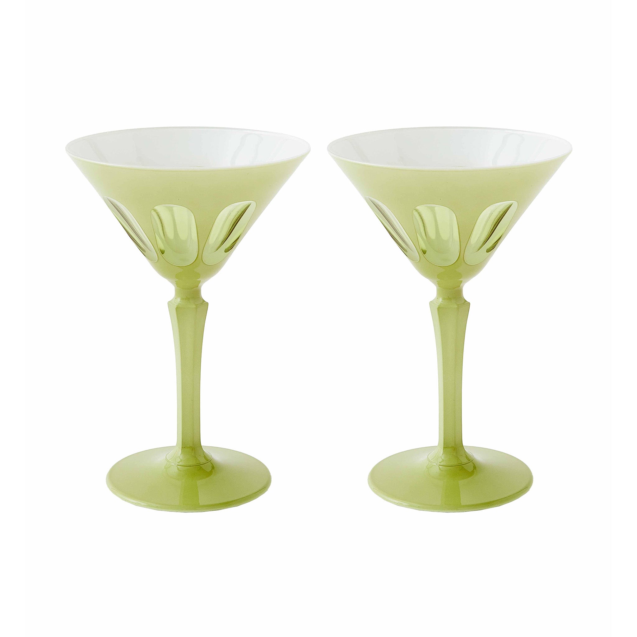 Two green martini glasses with white interiors on a white background