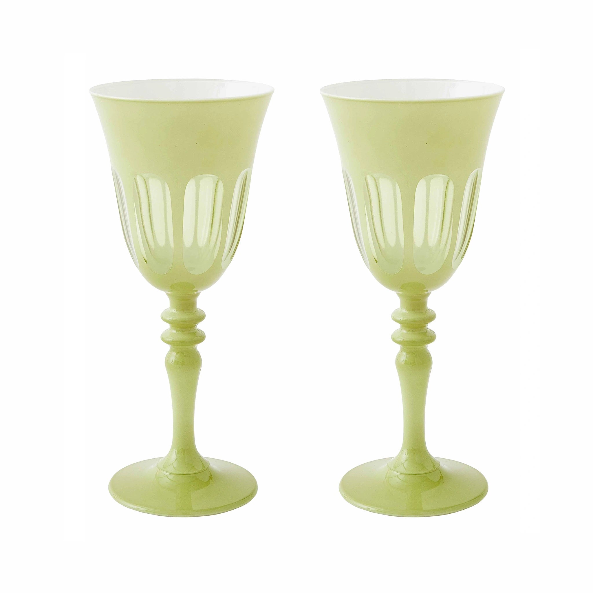Two light green goblets with decorative stems on a white background