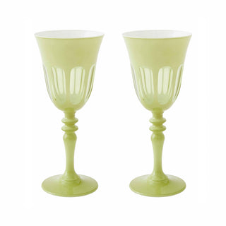 Two light green goblets with decorative stems on a white background