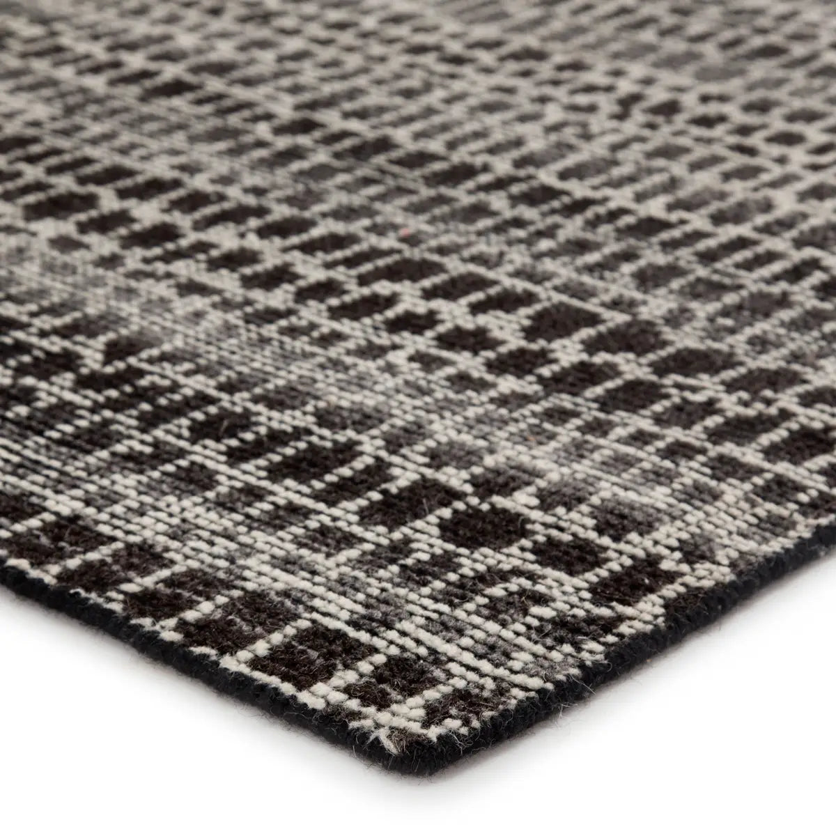 Close-up of a textured rug with a geometric pattern background