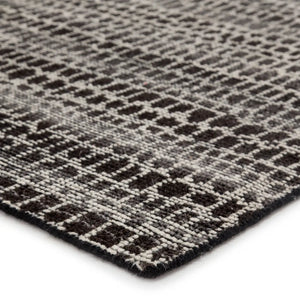 Close-up of a textured rug with a geometric pattern background