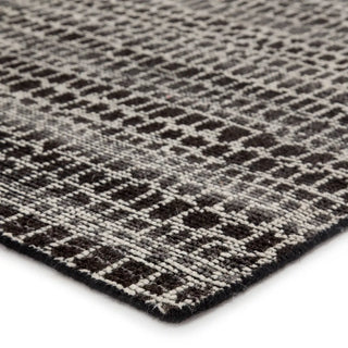 Close-up of a textured rug with a geometric pattern background