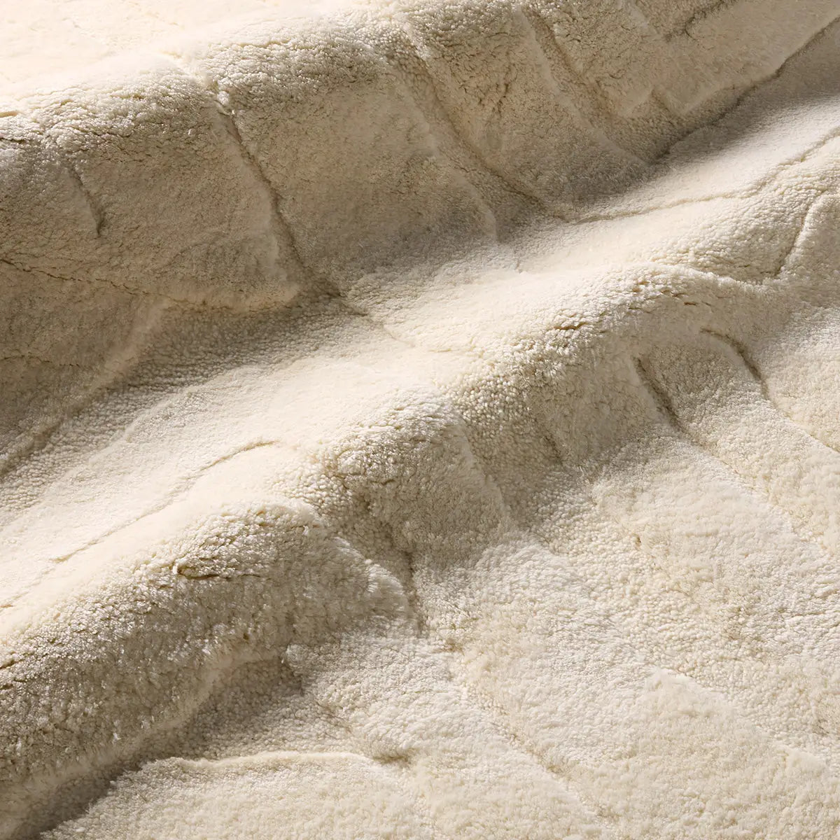 Beige textured area rug with wavy pattern 