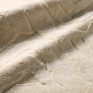 Beige textured area rug with wavy pattern 