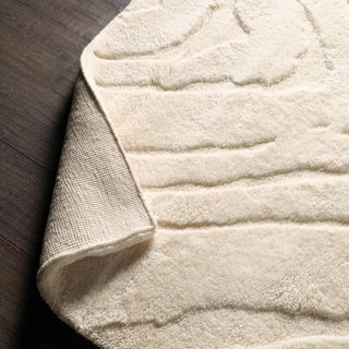 Beige textured area rug with wavy pattern 
