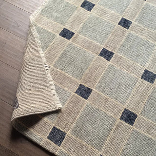 Checkered patterned rug on a wooden floor