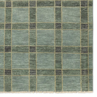 Checkered rug with a pattern of green and gray squares on a white background