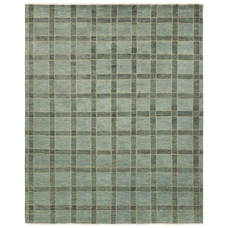 Checkered rug with a pattern of green and gray squares on a white background
