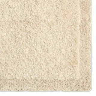 Close-up of a textured beige rug corner