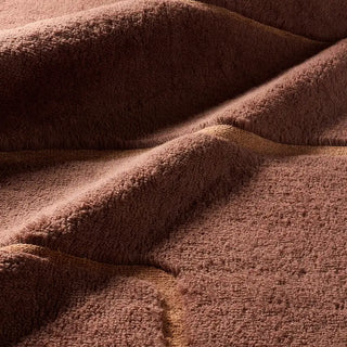 Close-up of rust textured wool rug