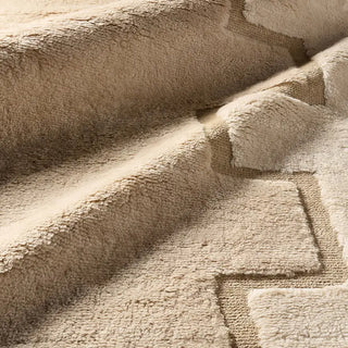 Close-up of beige textured rug with a subtle pattern