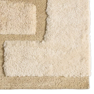 Close-up of a textured beige rug with a geometric pattern