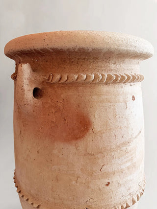 Terracotta pot with decorative elements on a white background