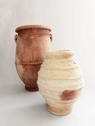 Two ceramic pots, one brown and one beige, on a white background