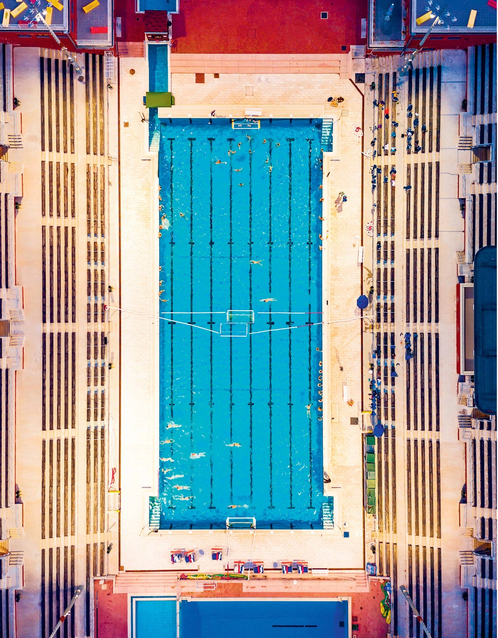 Aerial view of a swimming pool with blue water and white deck.