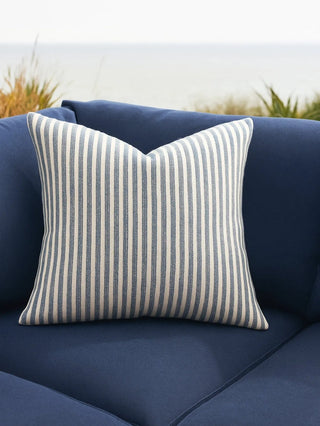Striped pillow on a blue outdoor sofa 