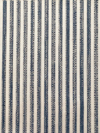 A close-up of a woven textile with vertical stripes in dark blue-gray and off-white, showing the fabric texture and pattern.