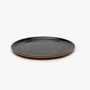 Round ceramic plate with a brown rim 