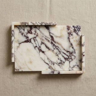 A rectangular marble serving tray with a cream and white base and dark brown veining, shown from a top-down view on a textured beige linen background.