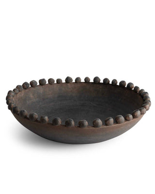 Decorative black bowl with bead-like embellishments on a white background