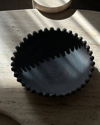 Dark bowl on a stone surface