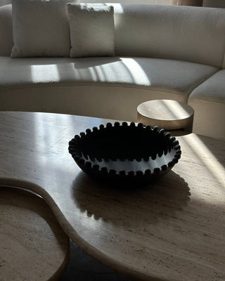 Dark bowl on stone coffee table.