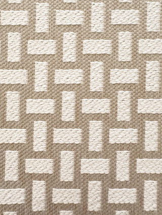 Close-up of a woven fabric pattern with alternating beige and off-white rectangular blocks in a basketweave-style