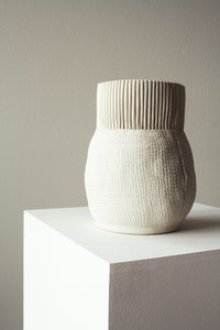 Handmade cream colored porcelain ceramic flower vase or jar with burlap imprinted and ribbed stripe pattern 