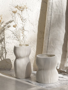 Textured curved shape porcelain decorative vase unglazed white ribbed