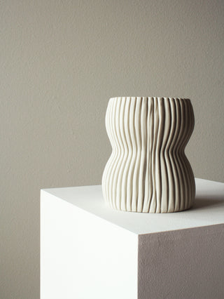Textured curved shape porcelain decorative vase unglazed white ribbed